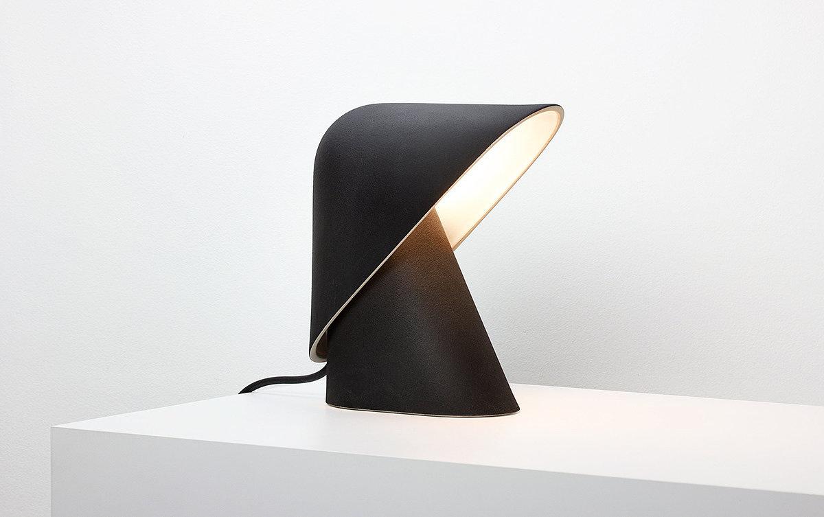 Front view of a sculptural table lamp showcasing expressive geometry and refined architectural detailing.