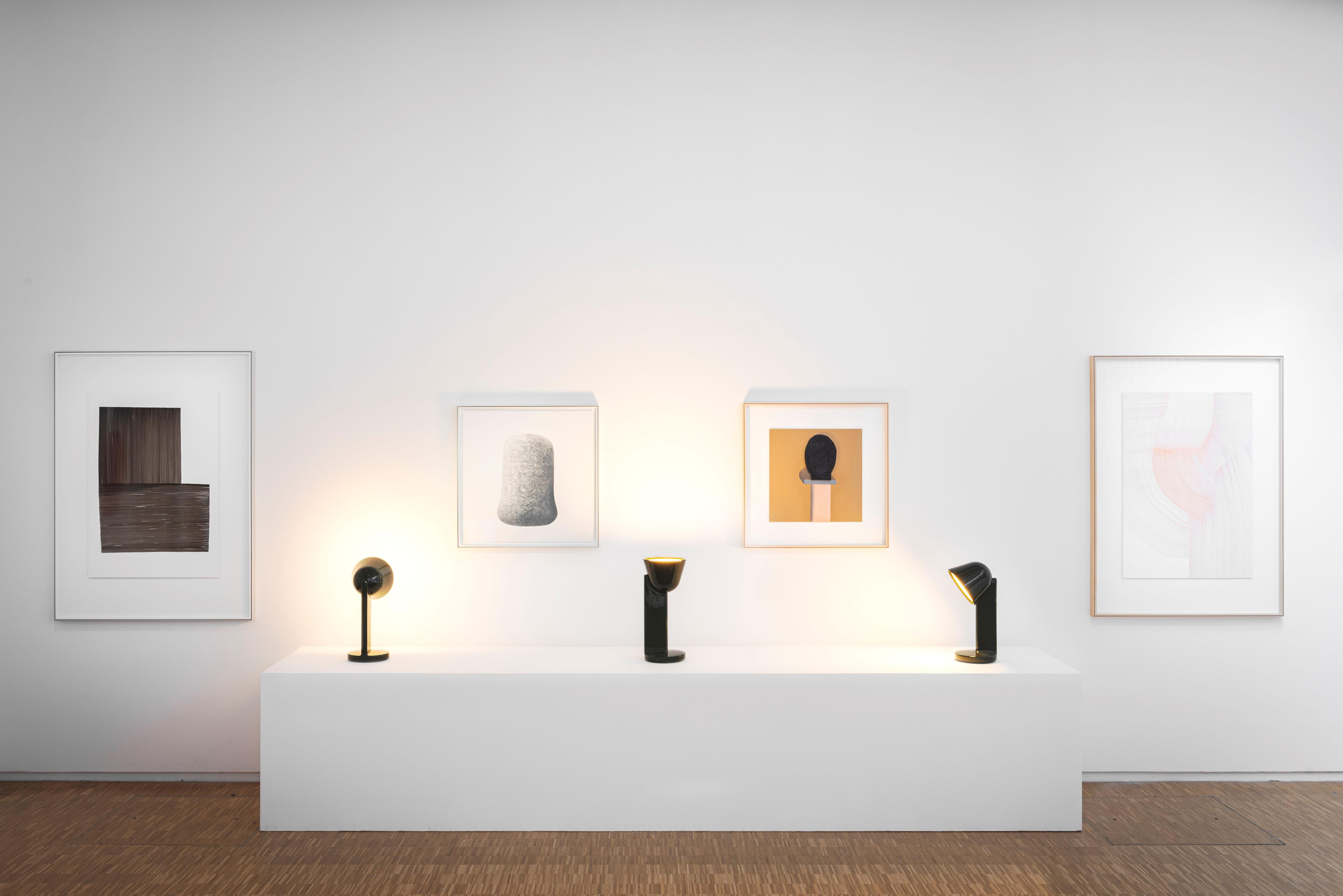 Sculptural table lamp displayed in a luxury hotel lobby creating an artistic focal point with elegant ambient lighting.
