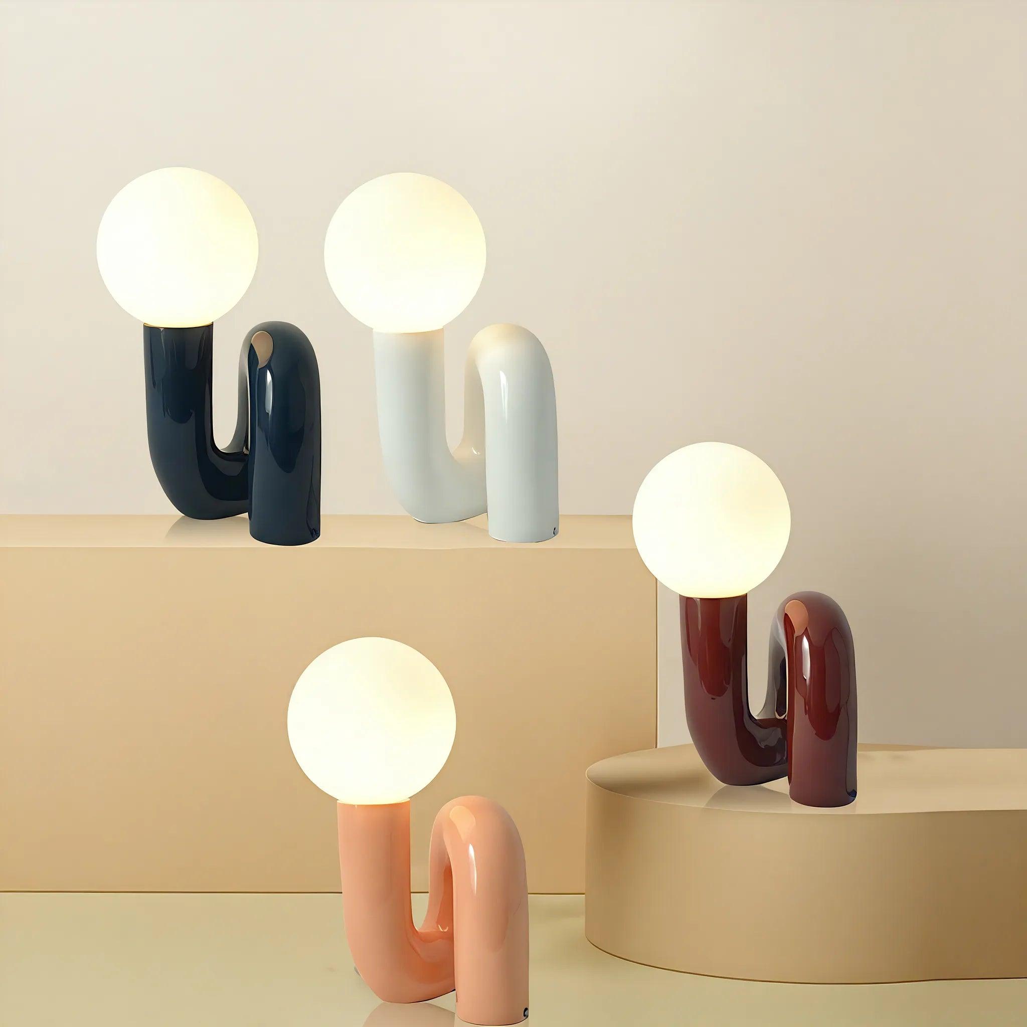 Collection of sculptural table lamps featuring contemporary artistic forms and premium decorative finishes.
