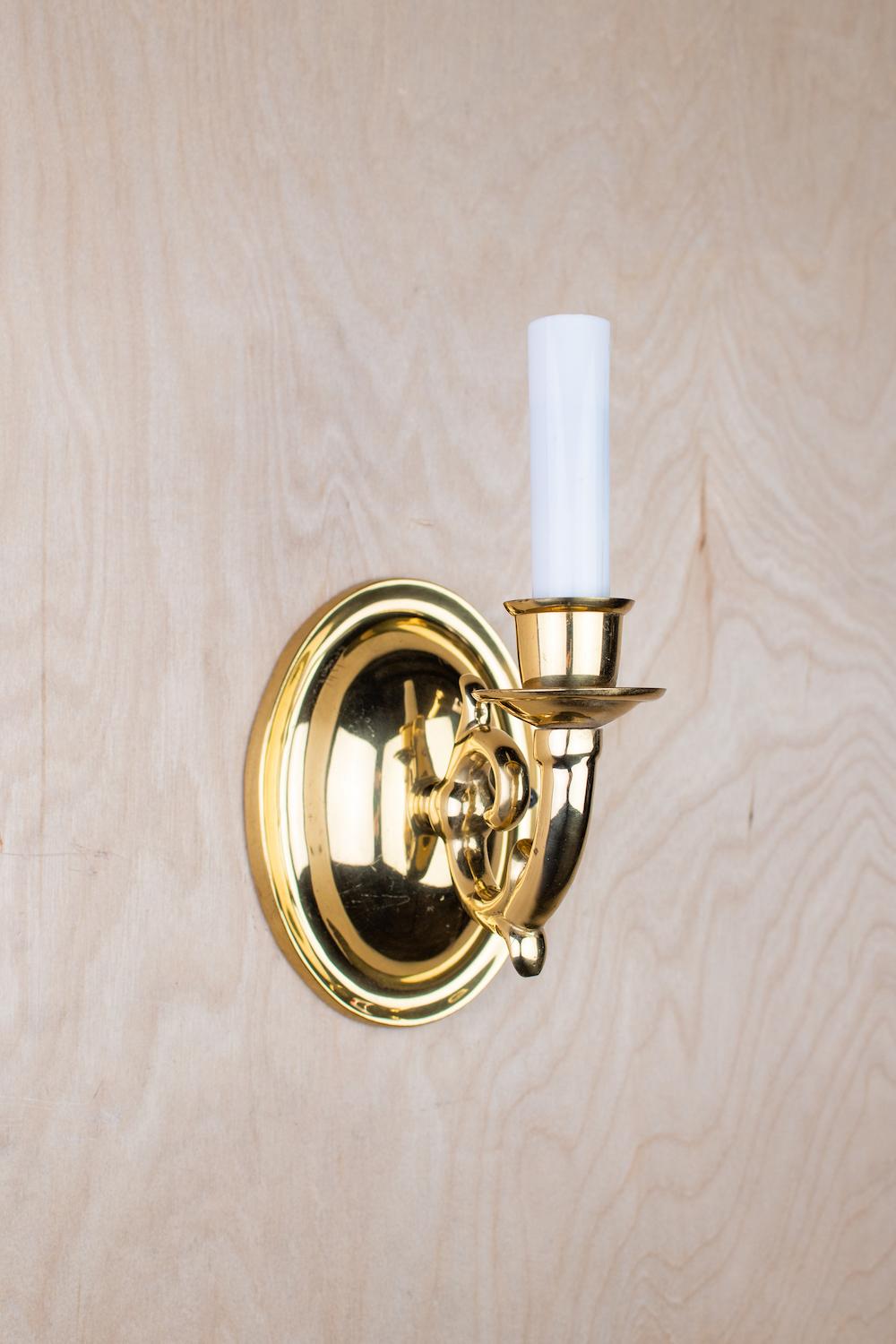 Front view of an elegant candle wall lamp featuring traditional European styling.