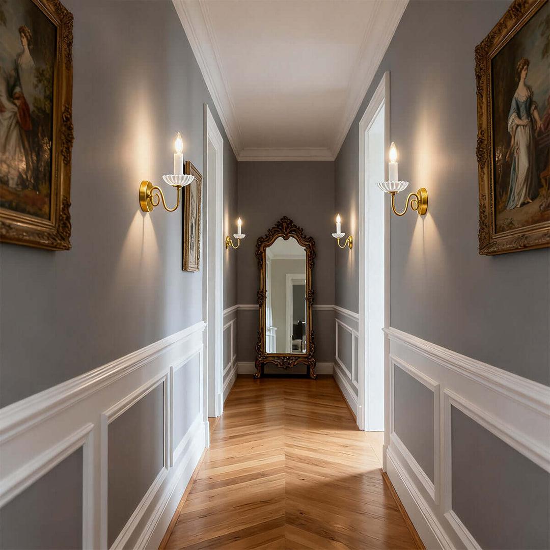 Candle wall lamp installed in a luxury hospitality interior with timeless architectural detailing.