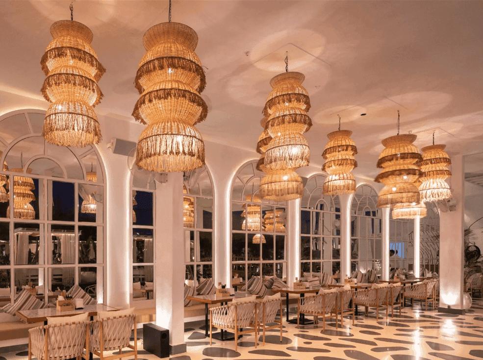 Woven chandelier installed in a luxury resort restaurant with contemporary natural architecture.