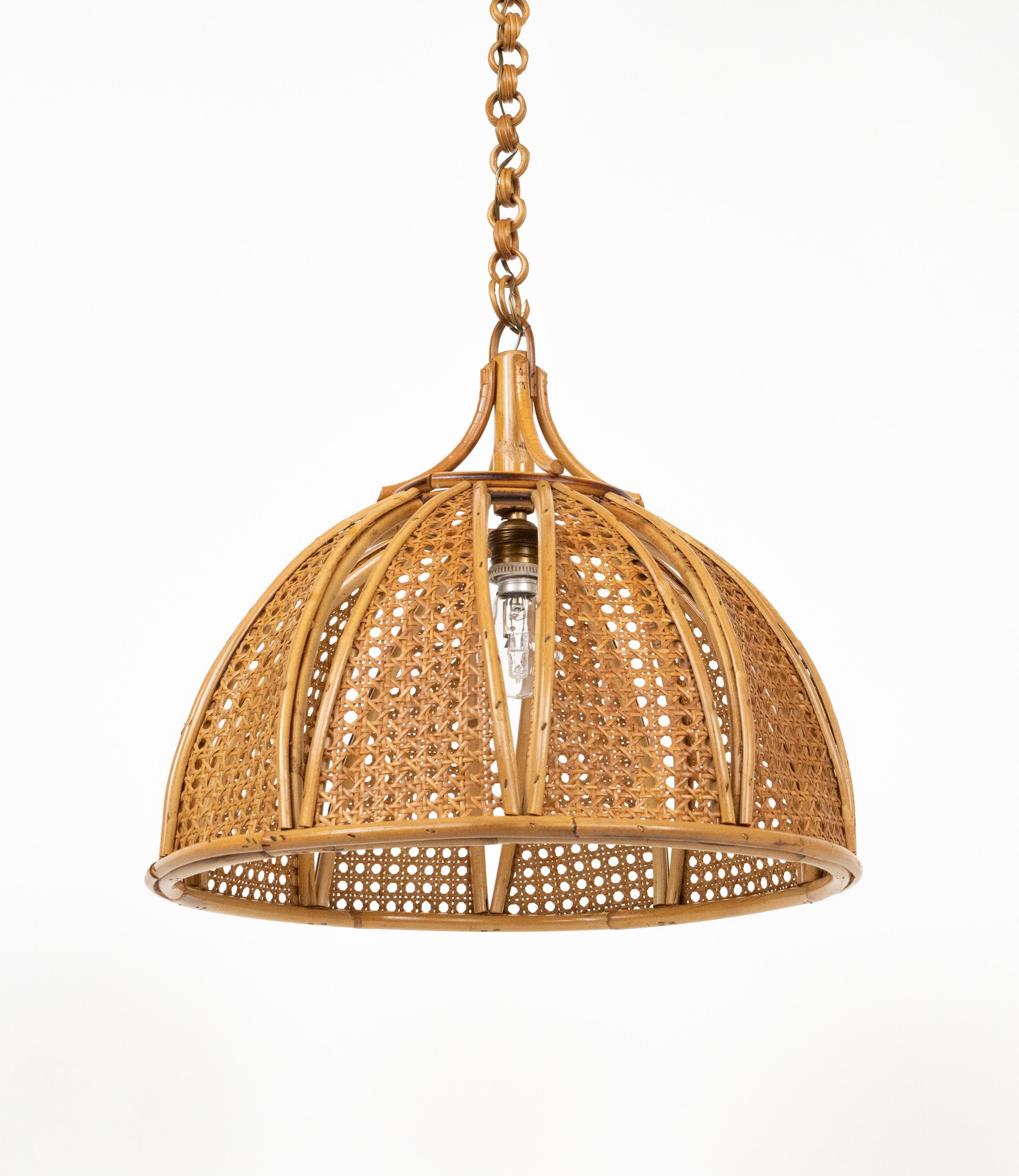 Handwoven rattan chandelier photographed on a clean white studio background.