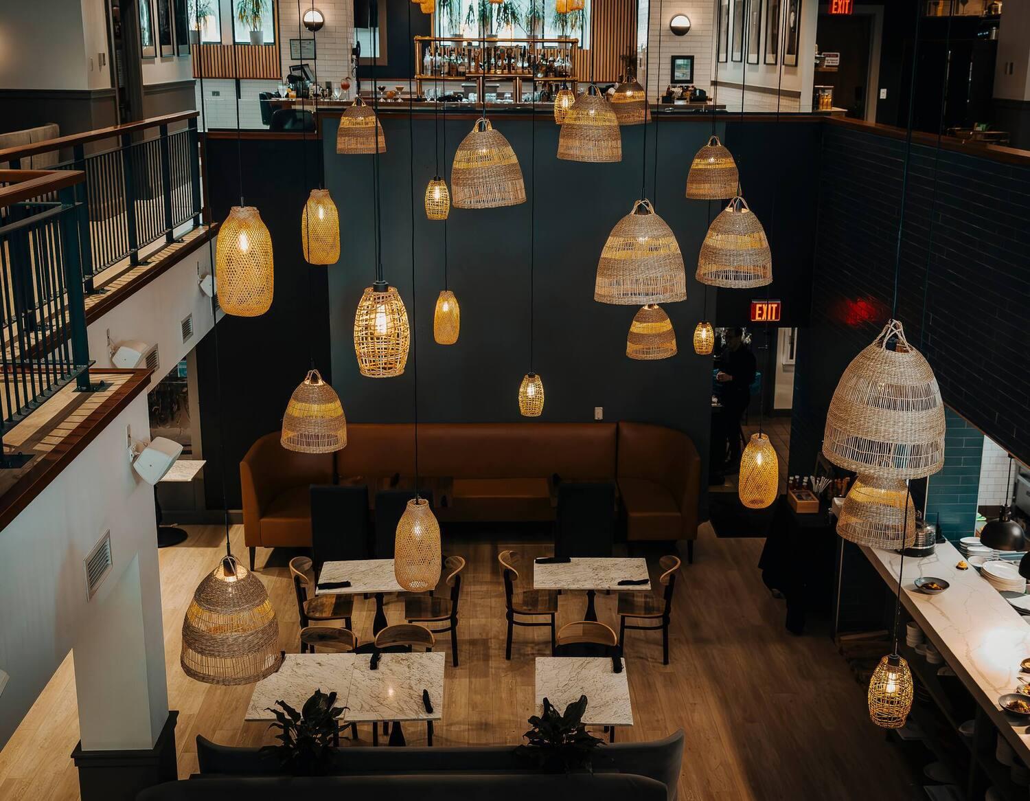 Woven chandelier installed in a luxury resort restaurant with contemporary natural architecture.