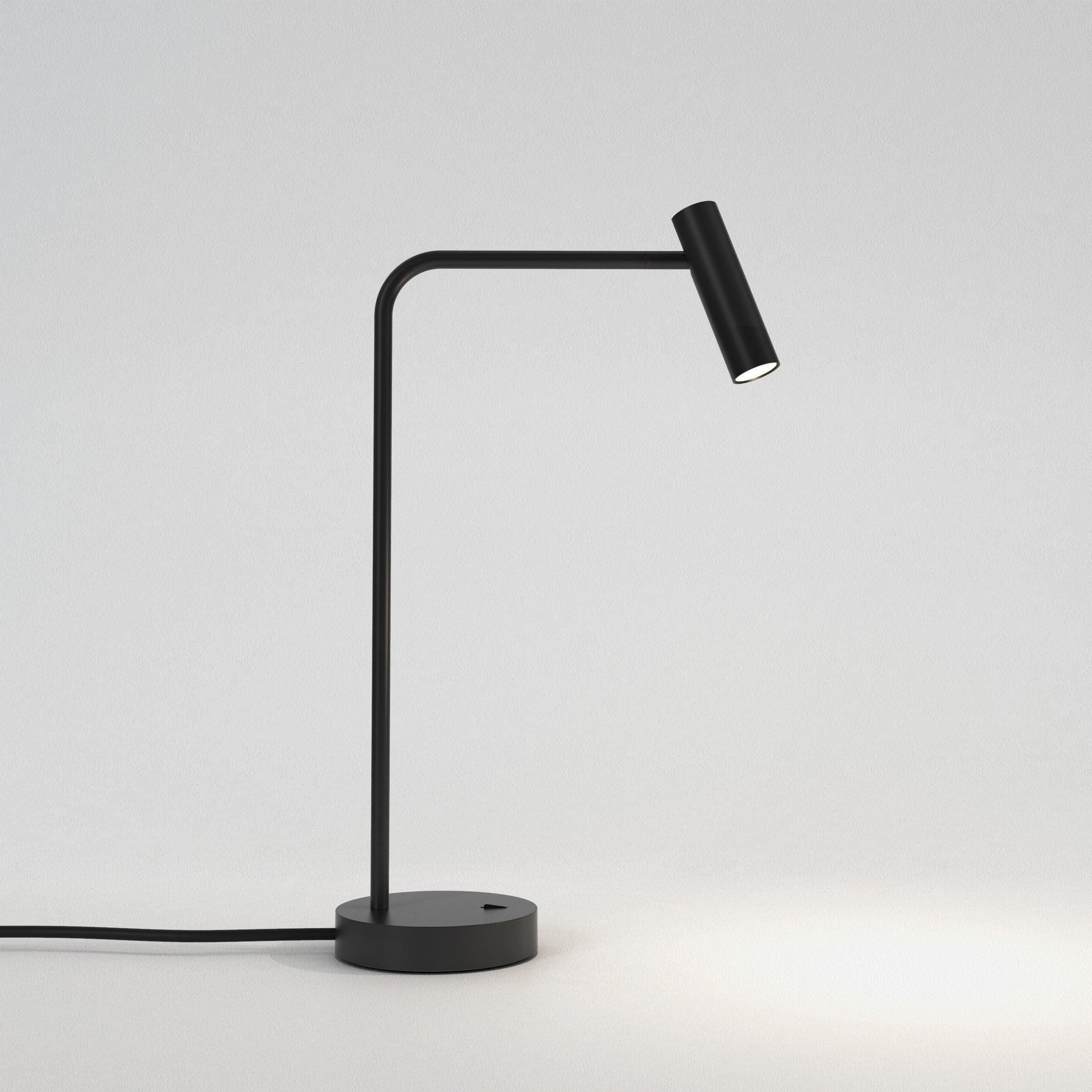 Front view of a reading table lamp highlighting its directional light head and elegant contemporary styling.