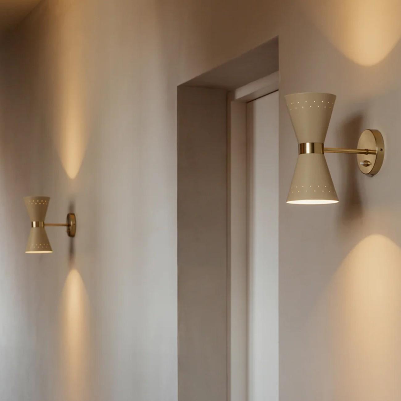 Scandinavian wall lamp installed in a minimalist residential interior with warm natural finishes.