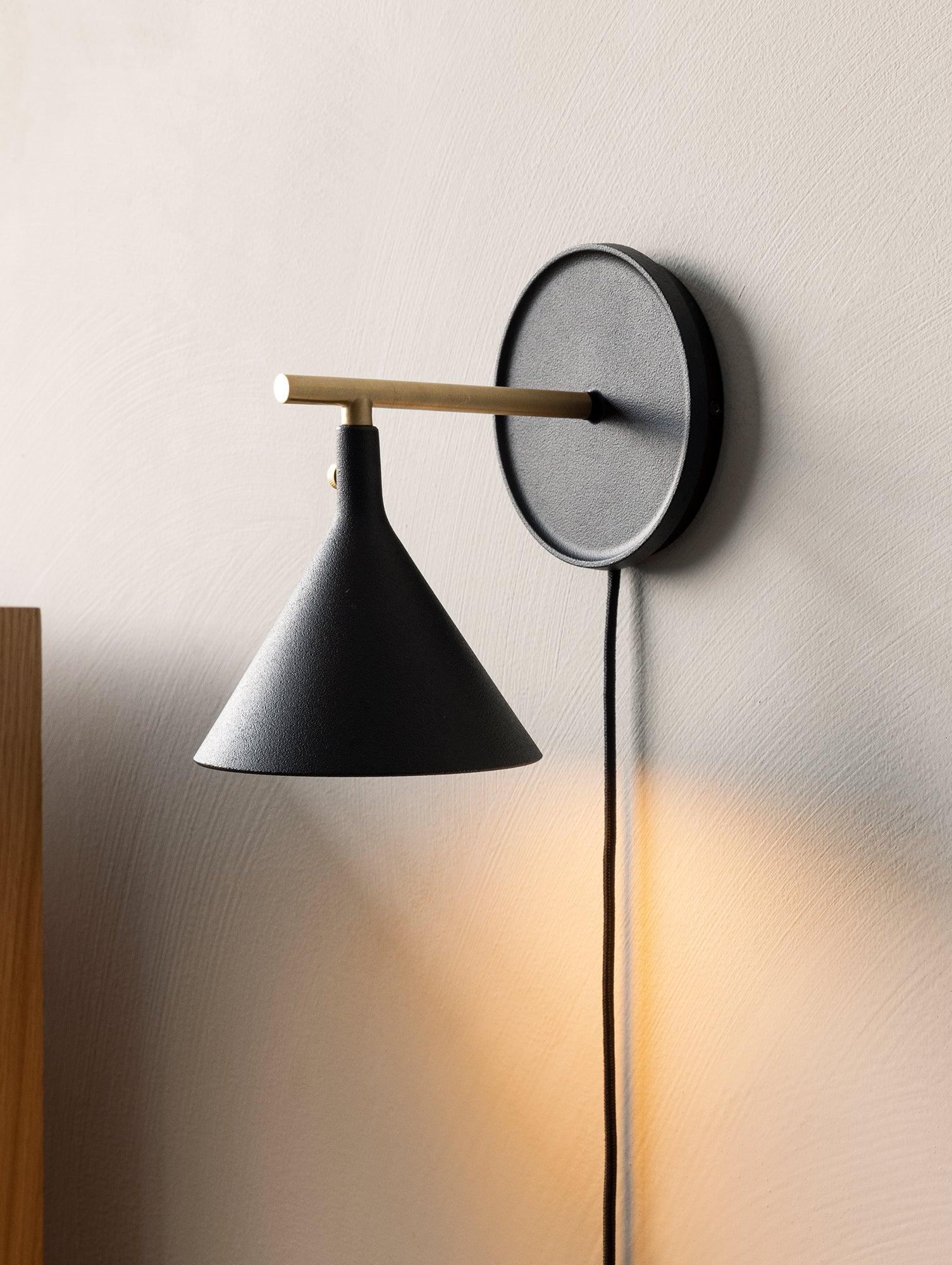 Front view of a Scandinavian wall lamp with natural materials and clean architectural lines.