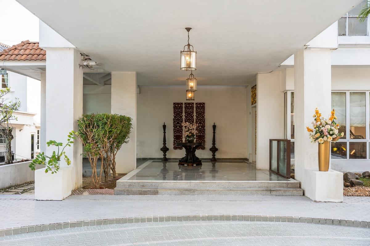 Lantern chandelier installed in a luxury residential entrance hall with timeless architectural styling.