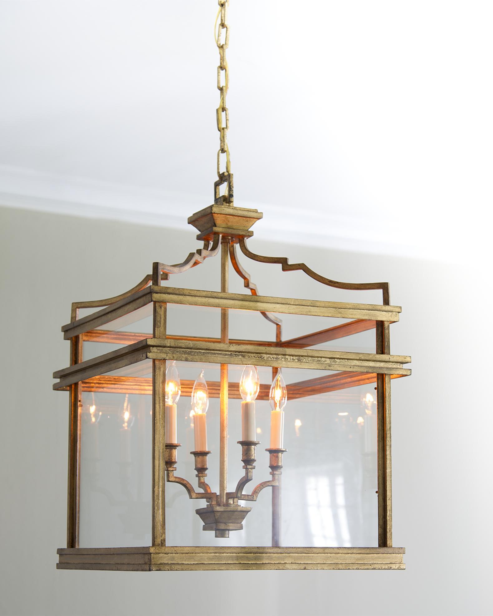 Front view of a geometric lantern chandelier with refined metal framing.