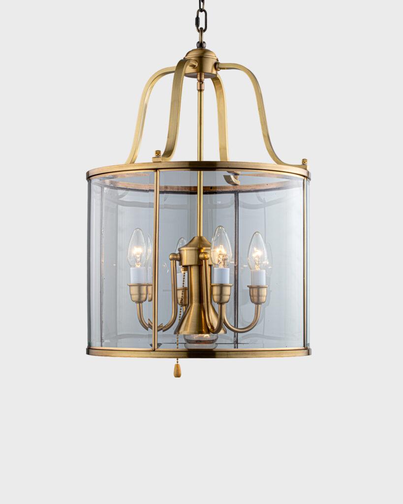 Front view of a geometric lantern chandelier with refined metal framing.