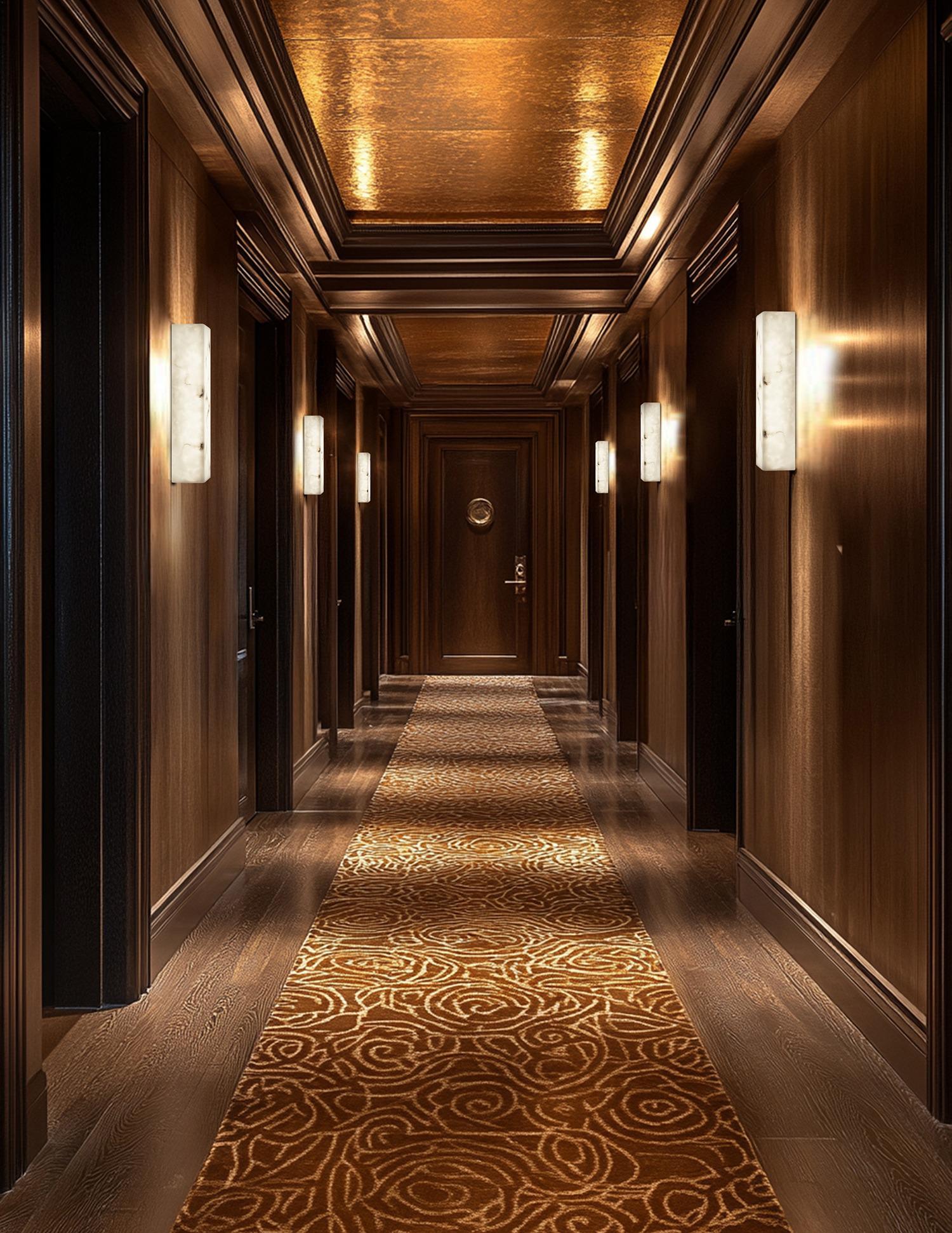 Contemporary wall lamp installed in a luxury hotel interior with sophisticated architectural styling.