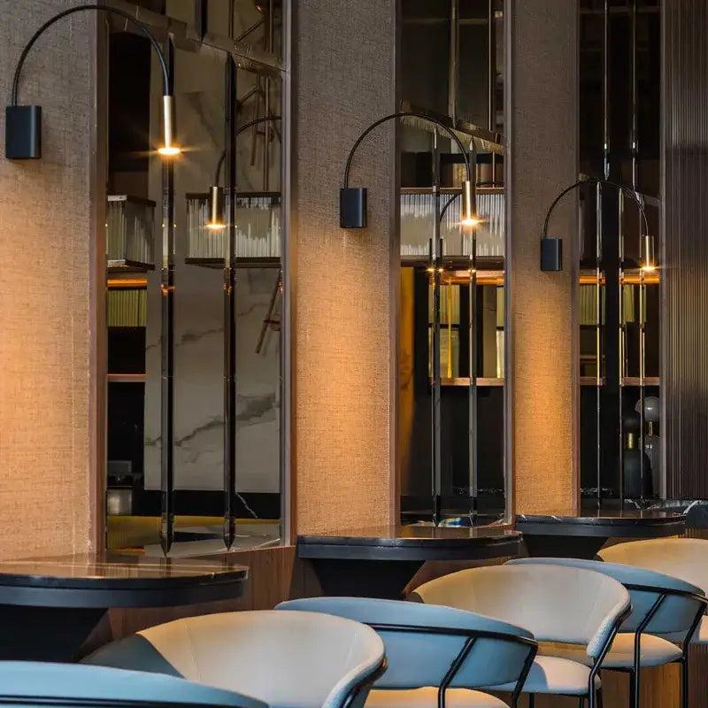 Contemporary wall lamp installed in a luxury hotel interior with sophisticated architectural styling.