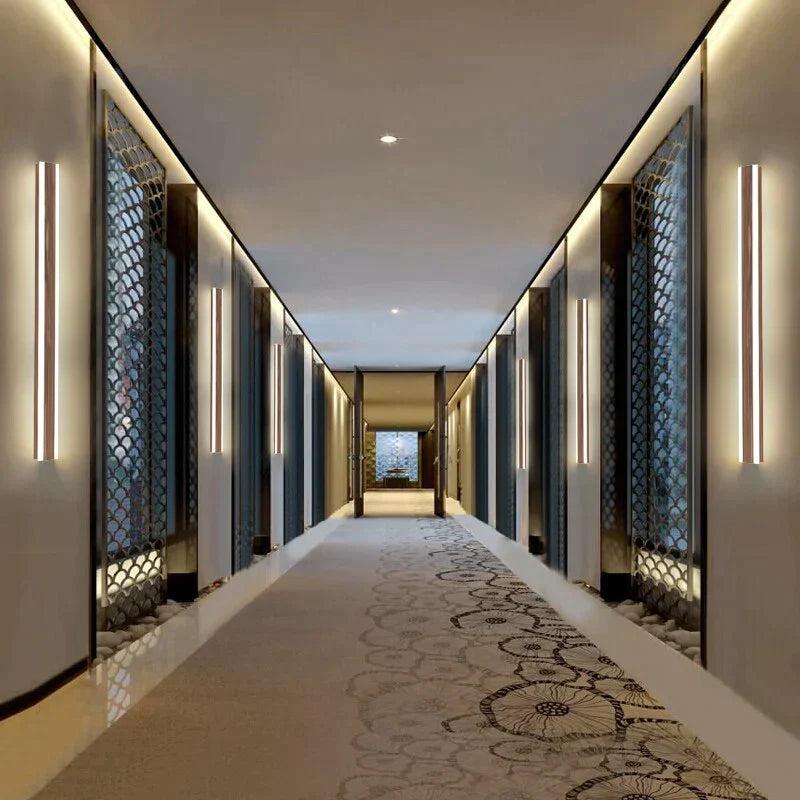 Contemporary wall lamp installed in a luxury hotel interior with sophisticated architectural styling.