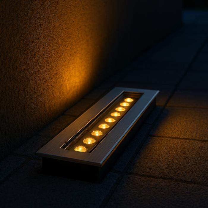 Wall grazing inground lights highlighting a contemporary building façade.