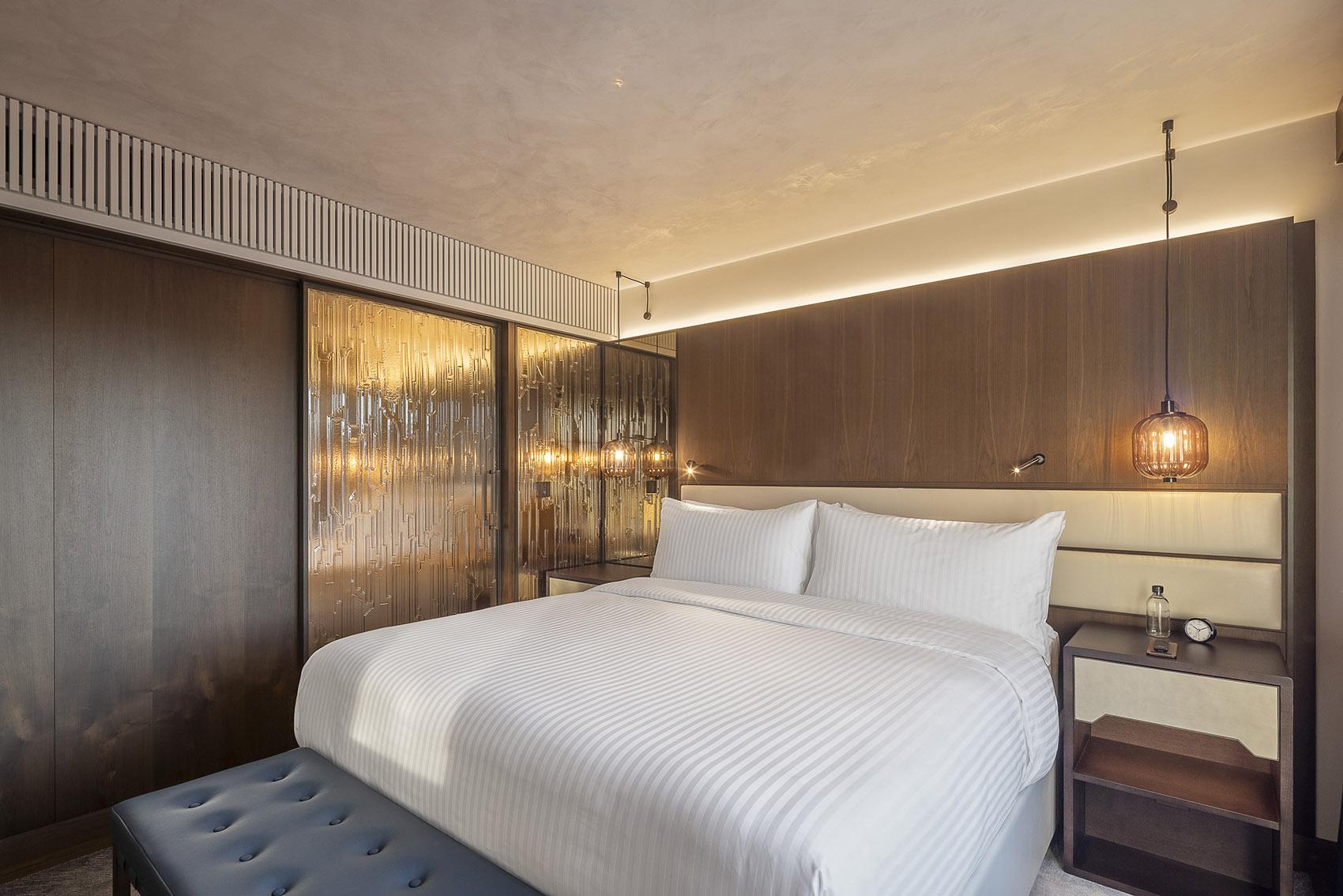 Luxury wall lamp installed in a five-star hotel interior with sophisticated architectural styling.