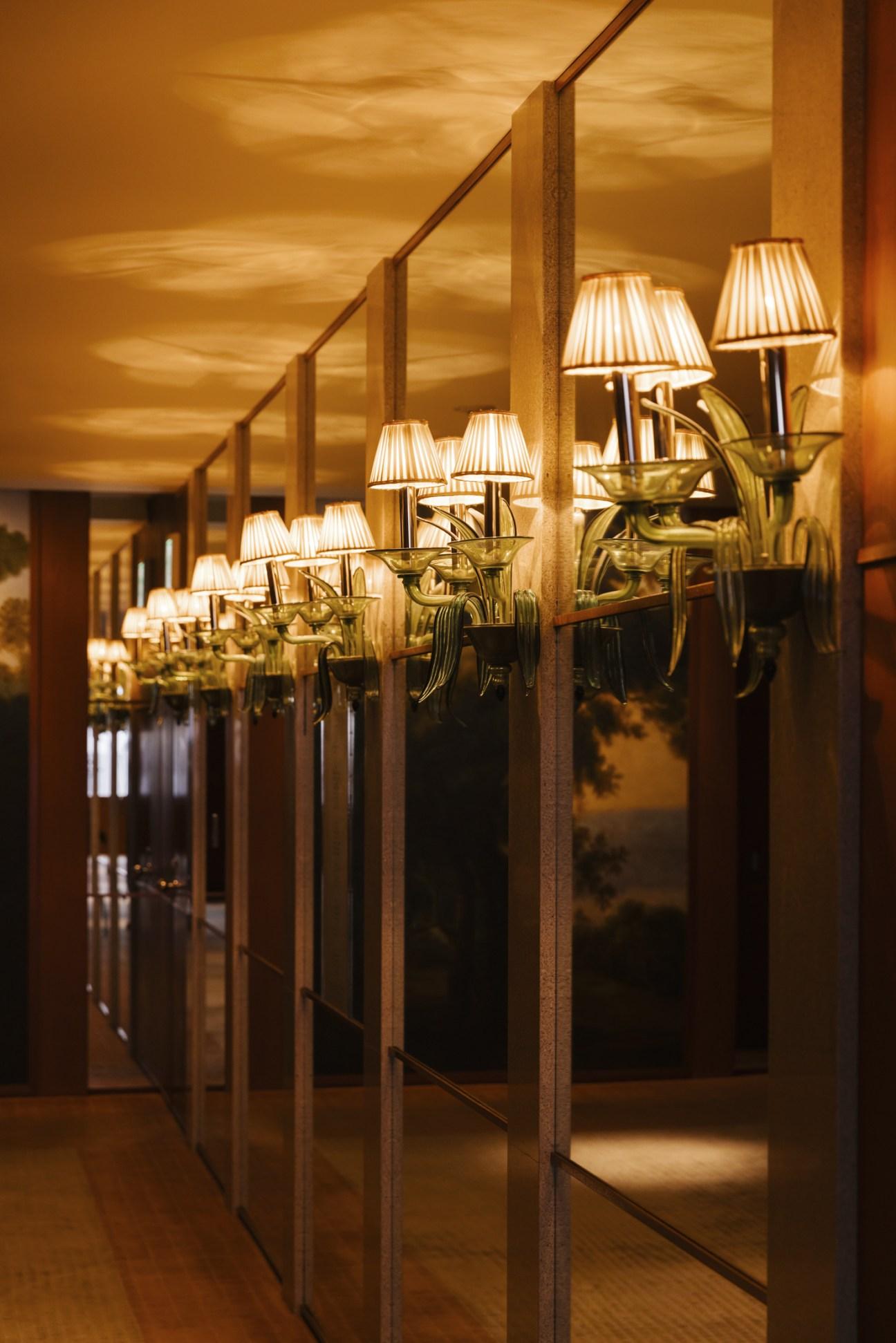 Luxury wall lamp installed in a five-star hotel interior with sophisticated architectural styling.