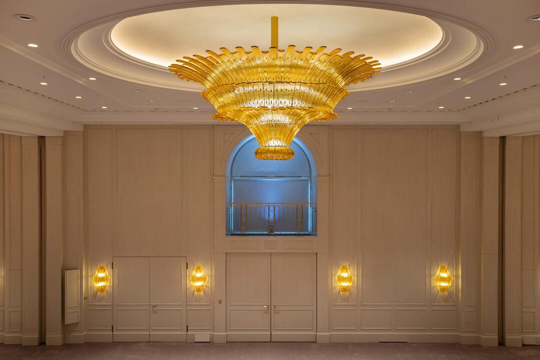 Murano chandelier installed in a luxury hospitality interior with refined architectural styling.