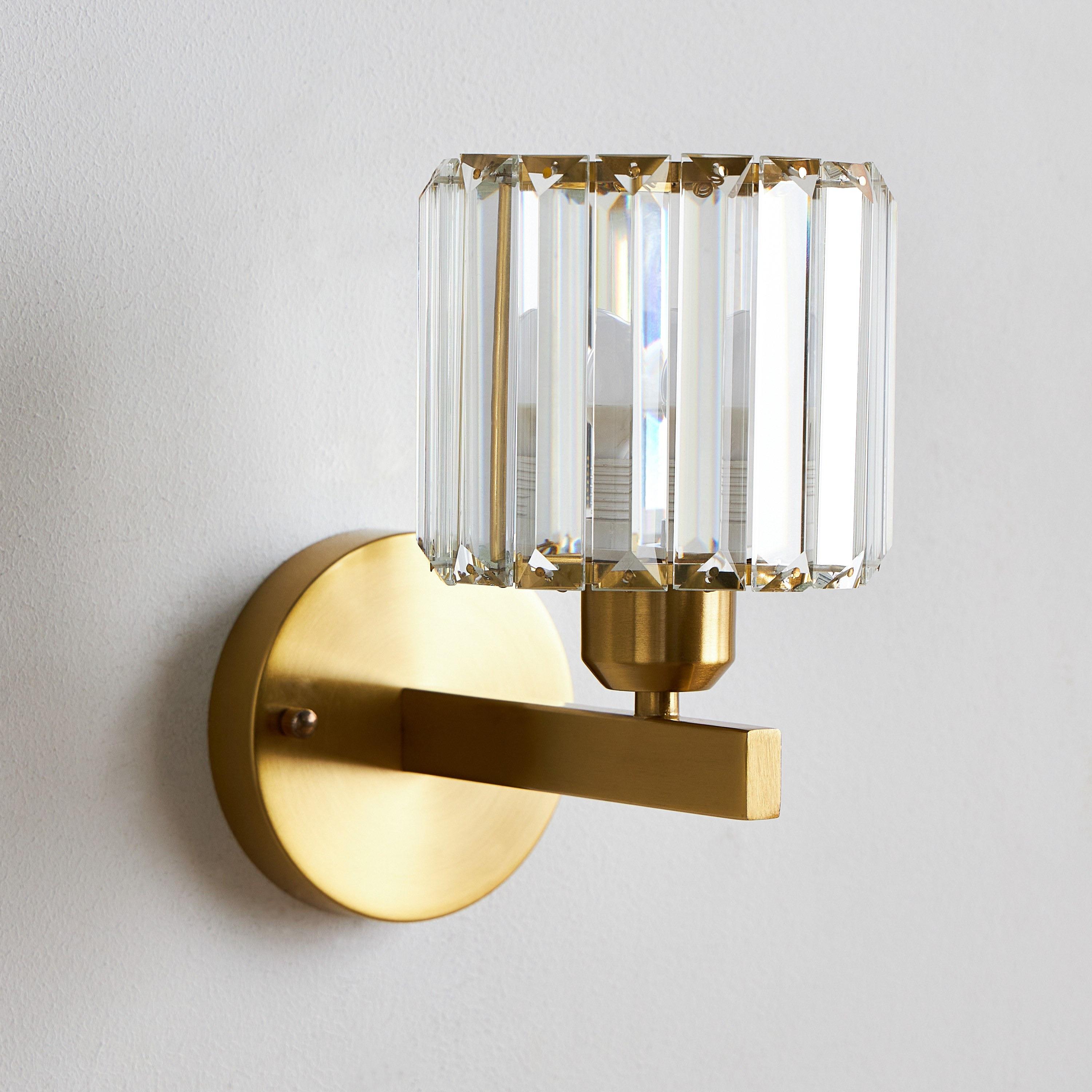 Front view of a luxury crystal wall lamp with elegant decorative detailing.