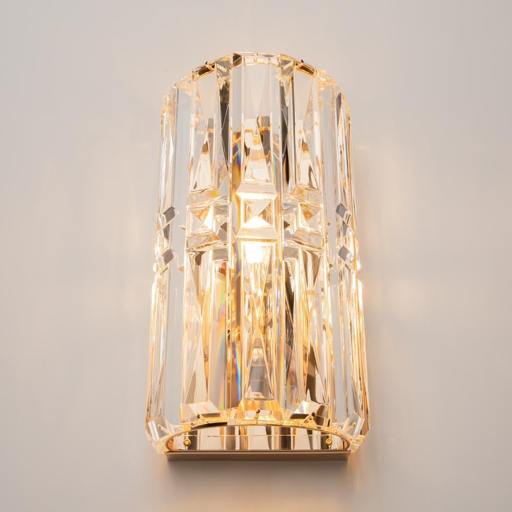 Front view of a luxury crystal wall lamp with elegant decorative detailing.