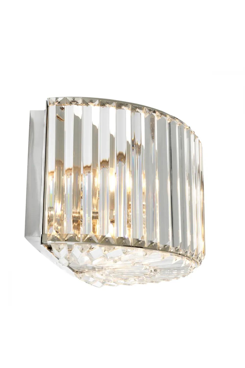 Crystal wall lamp photographed on a clean white studio background featuring precision-cut crystal elements.