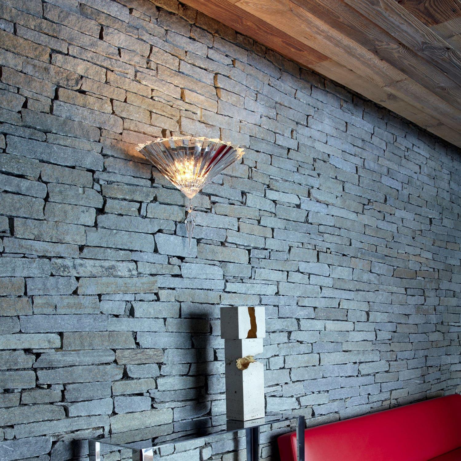 Crystal wall lamp installed in a luxury hotel lobby with refined architectural interiors.