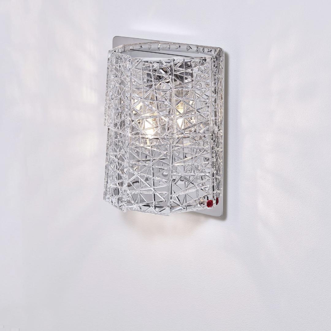 Front view of a luxury crystal wall lamp with elegant decorative detailing.