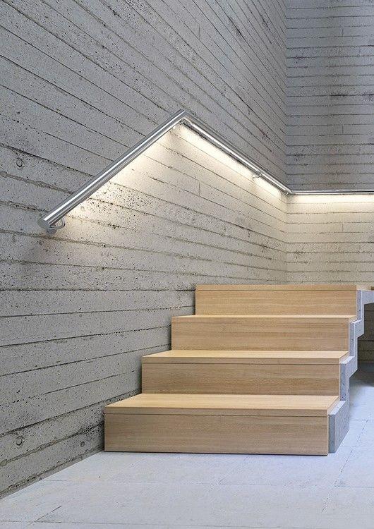 LED handrail profile integrated into a contemporary architectural staircase.