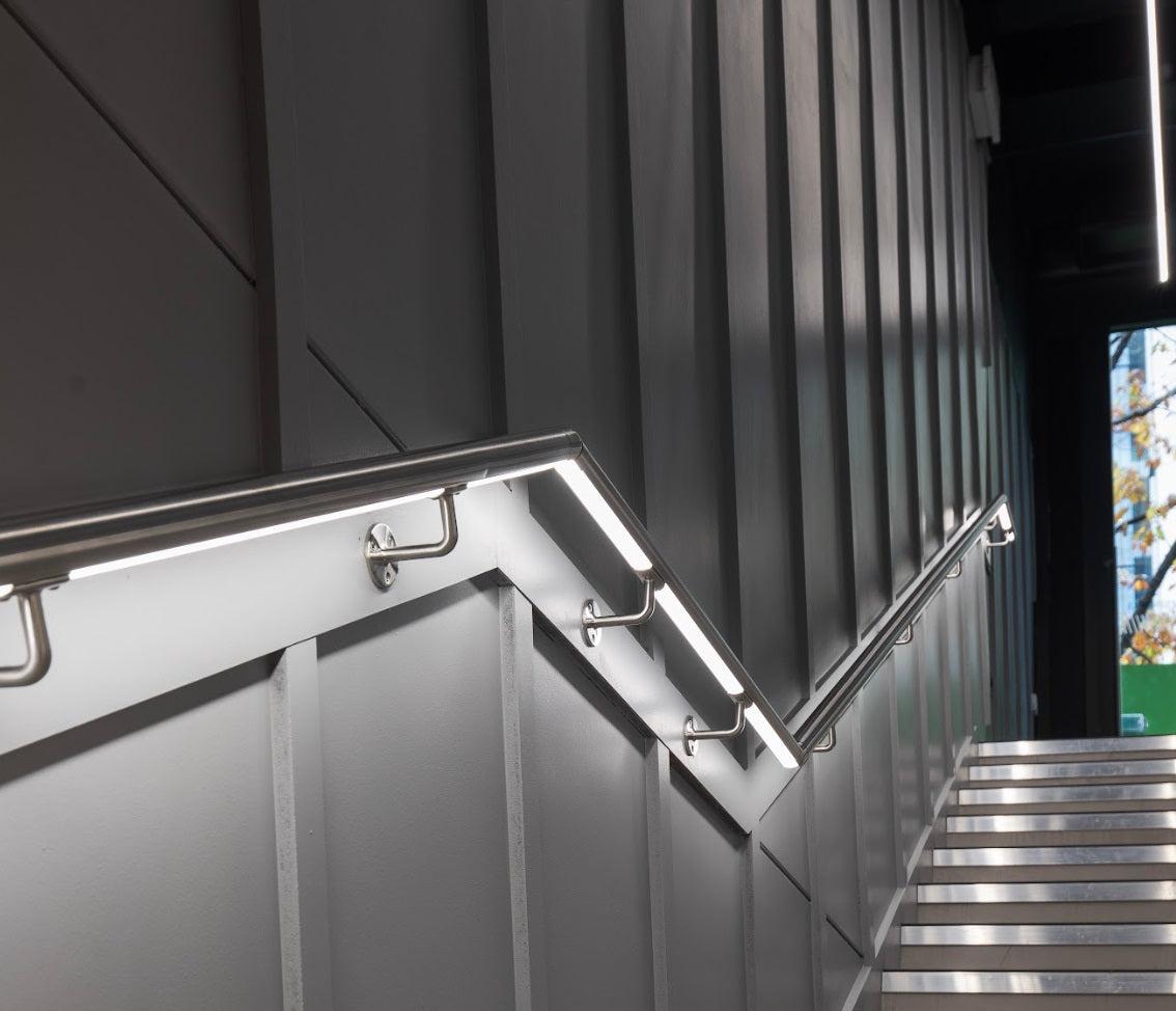LED handrail profile integrated into a contemporary architectural staircase.