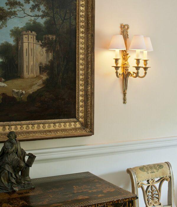 Classic wall lamp installed in a luxury heritage hotel with classical architectural interiors.