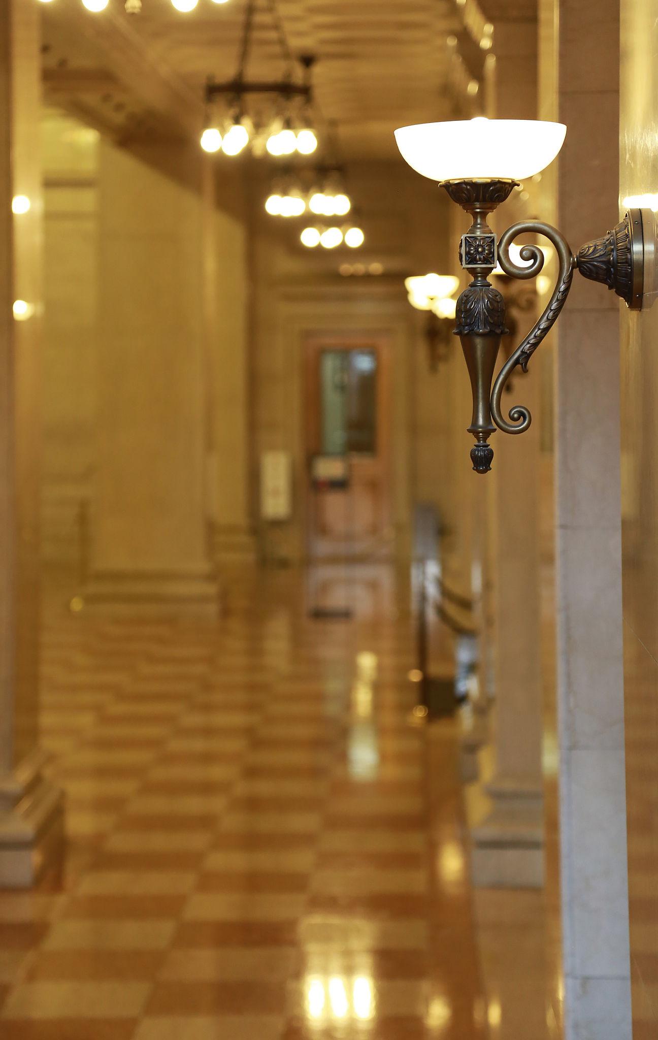 Classic wall lamp installed in a luxury heritage hotel with classical architectural interiors.