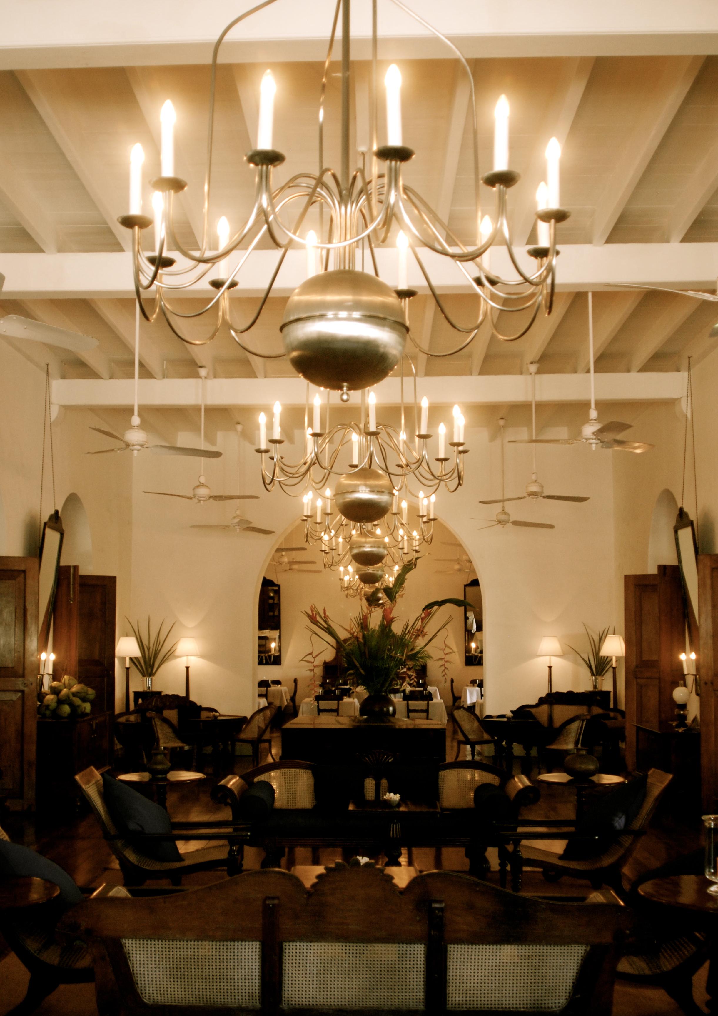 Candle chandelier installed in a luxury residential dining room with timeless architectural styling.