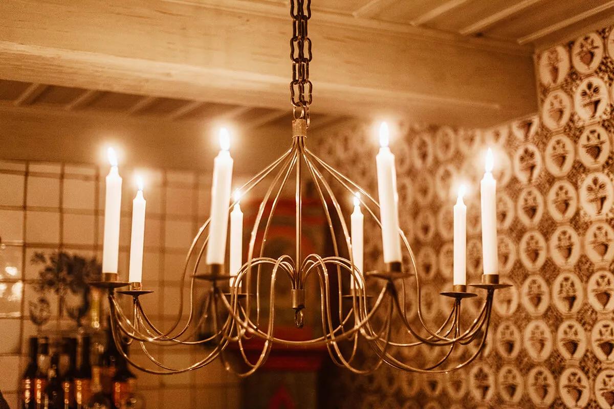 Candle chandelier installed in a luxury residential dining room with timeless architectural styling.