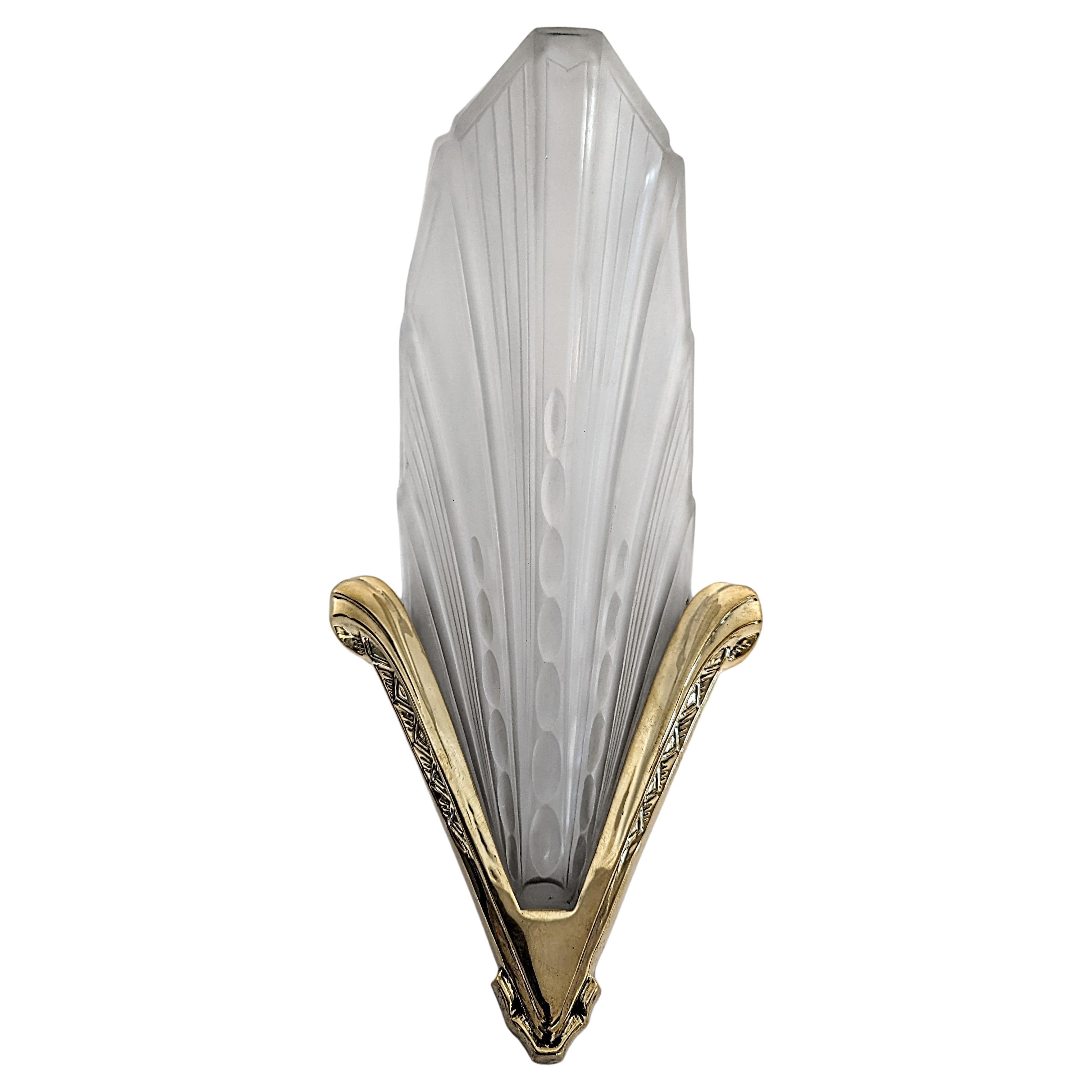 Art Deco wall lamp photographed on a clean white studio background featuring elegant geometric detailing.