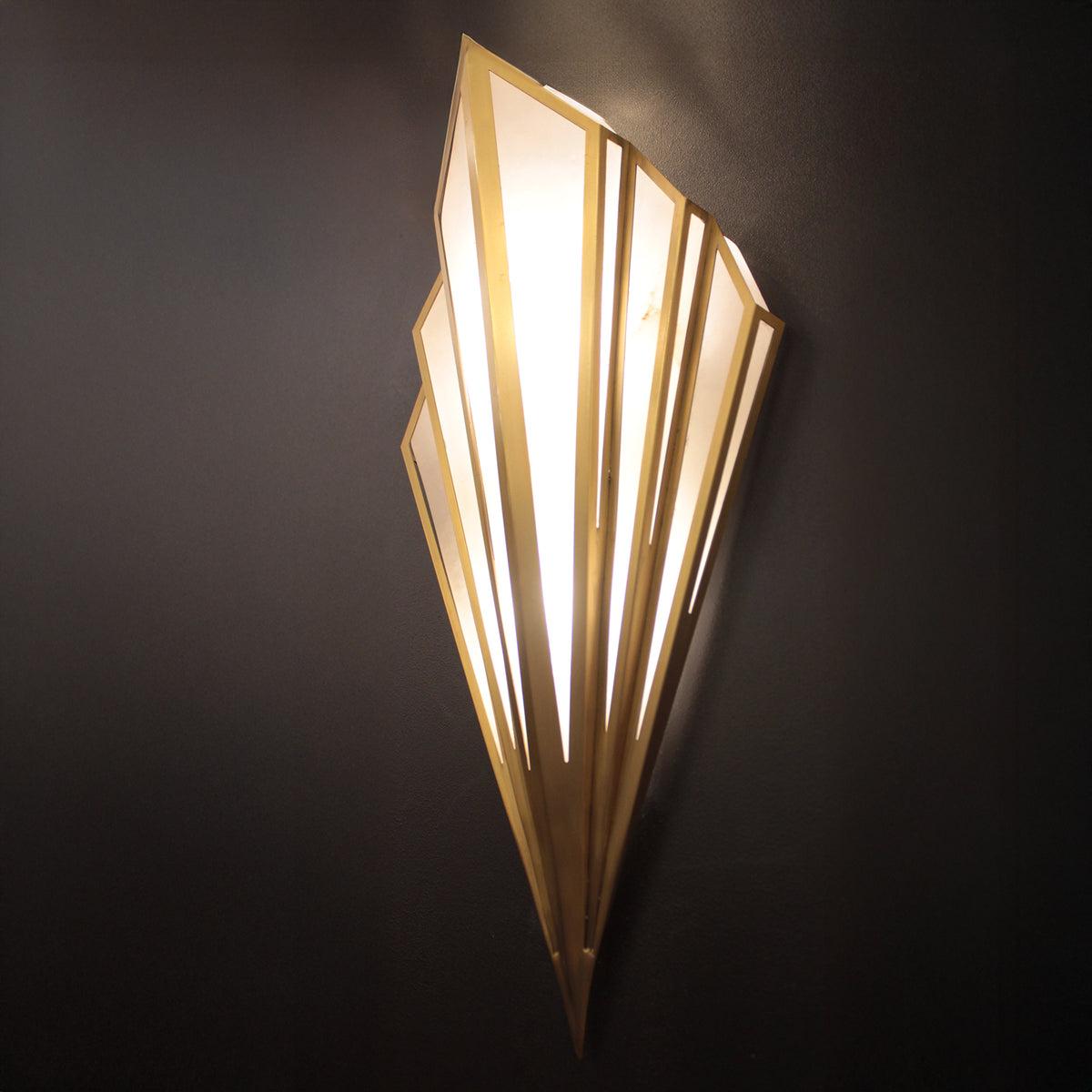 Front view of an Art Deco wall lamp with premium brass and decorative glass elements.