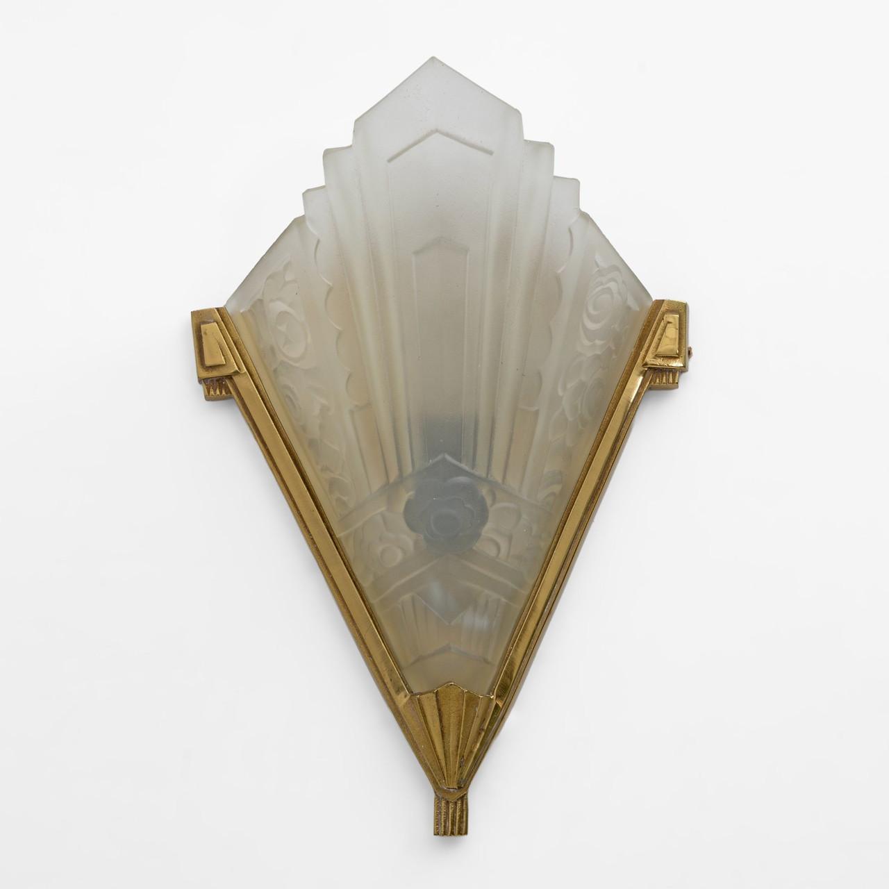 Front view of an Art Deco wall lamp with premium brass and decorative glass elements.