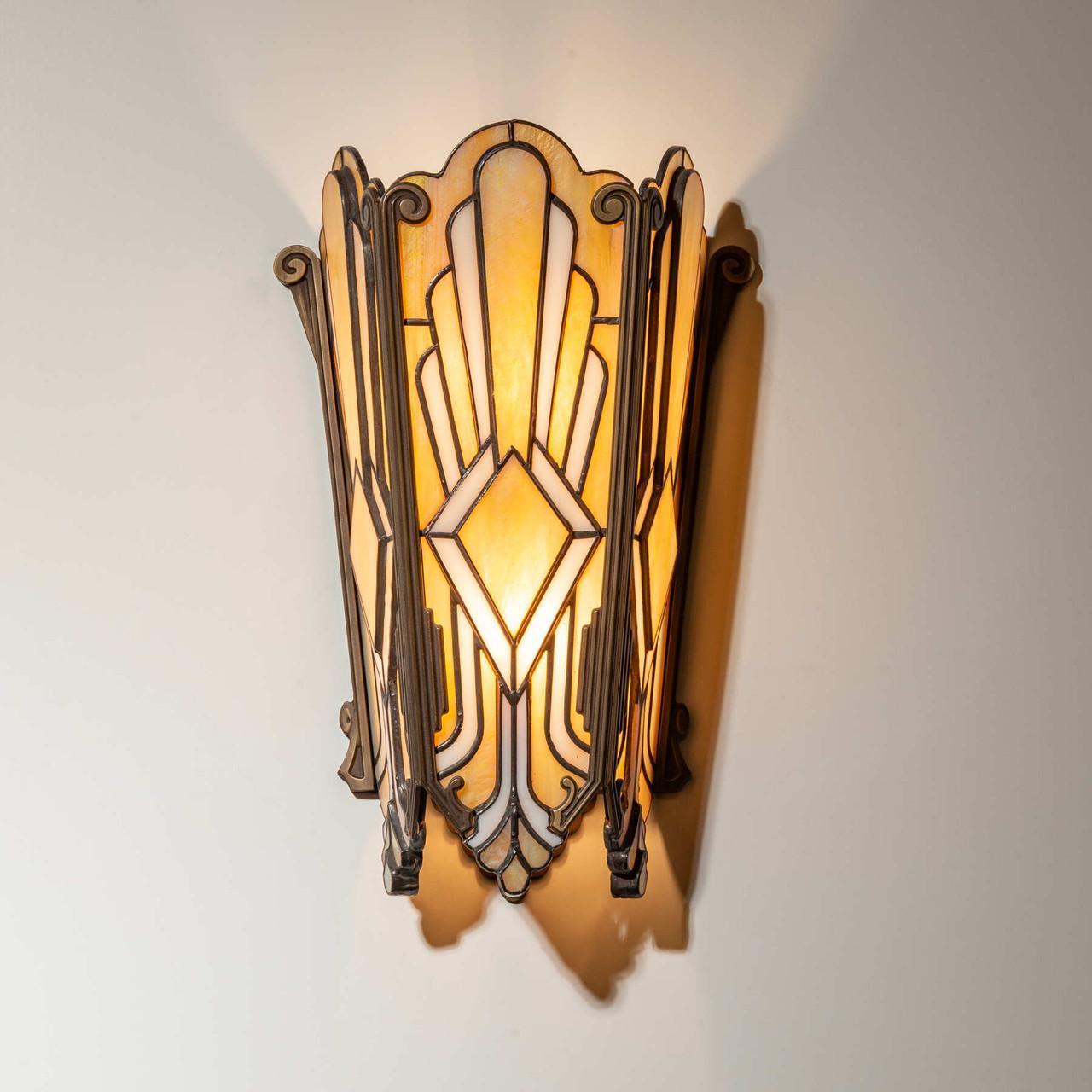 Front view of an Art Deco wall lamp with premium brass and decorative glass elements.