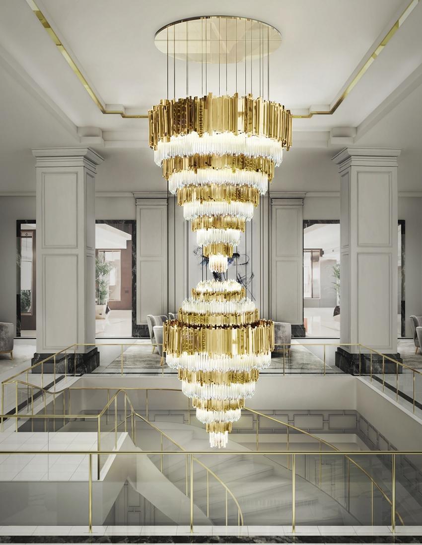 Tiered chandelier installed in a luxury hotel atrium with dramatic architectural lighting.