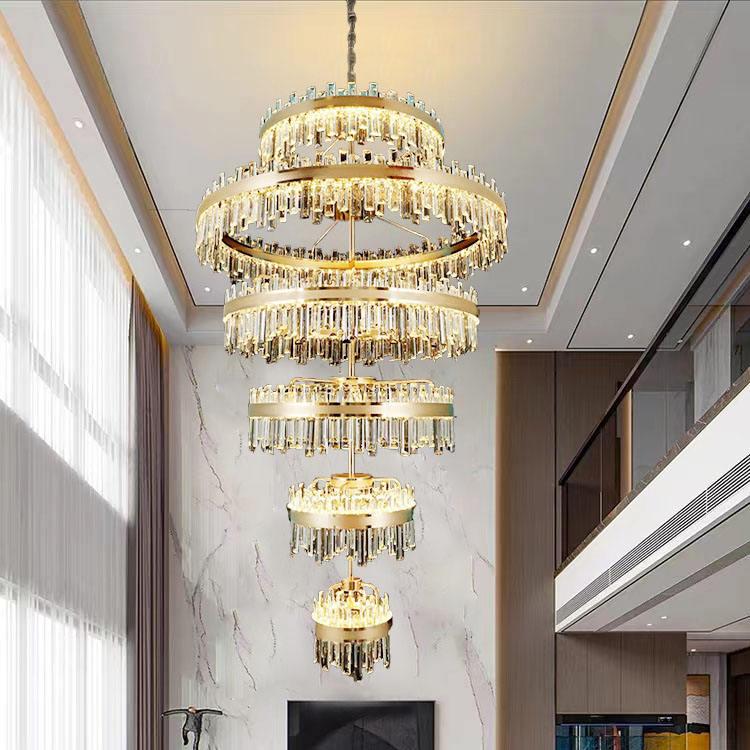 Tiered chandelier installed in a luxury hotel atrium with dramatic architectural lighting.