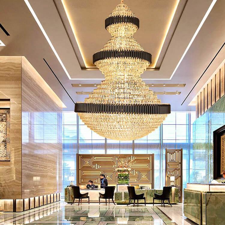 Tiered chandelier installed in a luxury hotel atrium with dramatic architectural lighting.