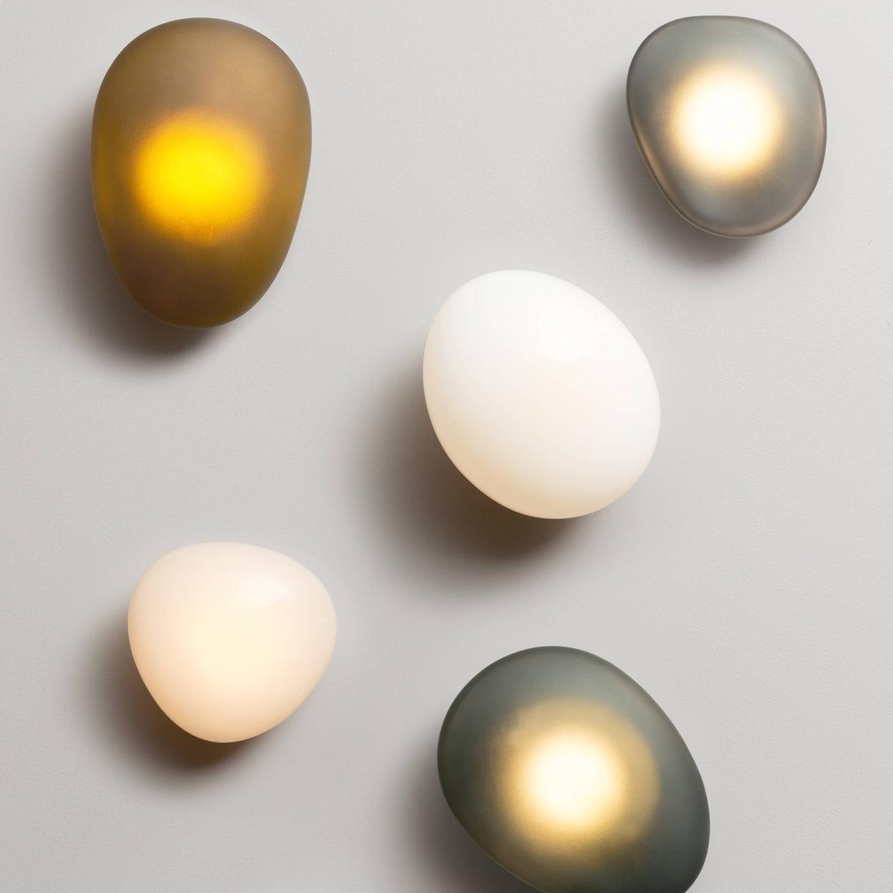Organic wall lamp family showcasing ceramic, glass and sculptural contemporary designs.