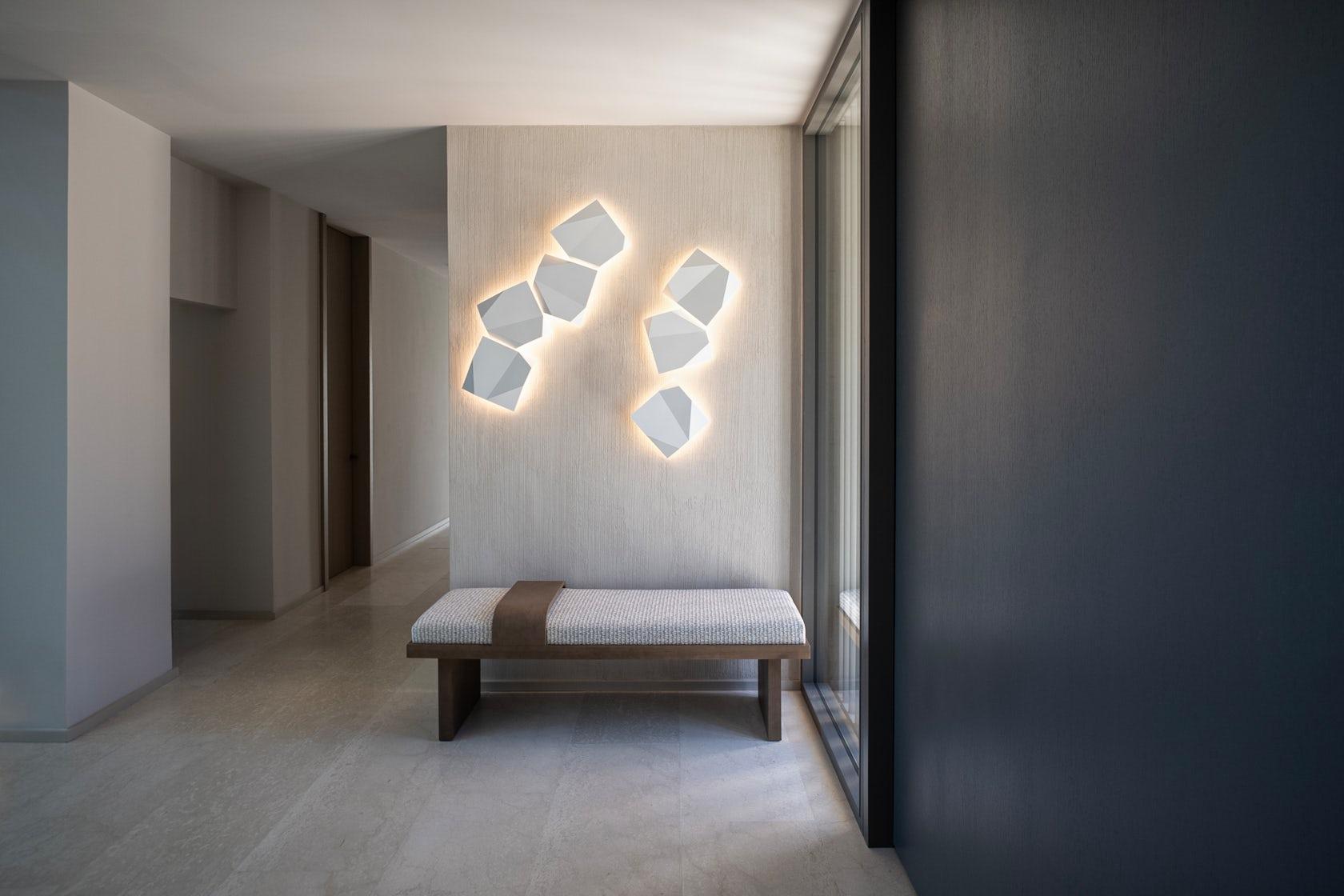 Organic wall lamp installed in a modern luxury residence with warm organic architectural styling.