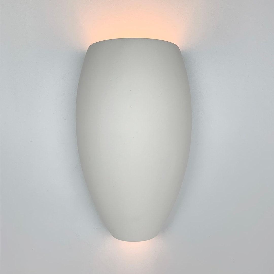 Front view of an organic wall lamp with soft curves and refined architectural detailing.