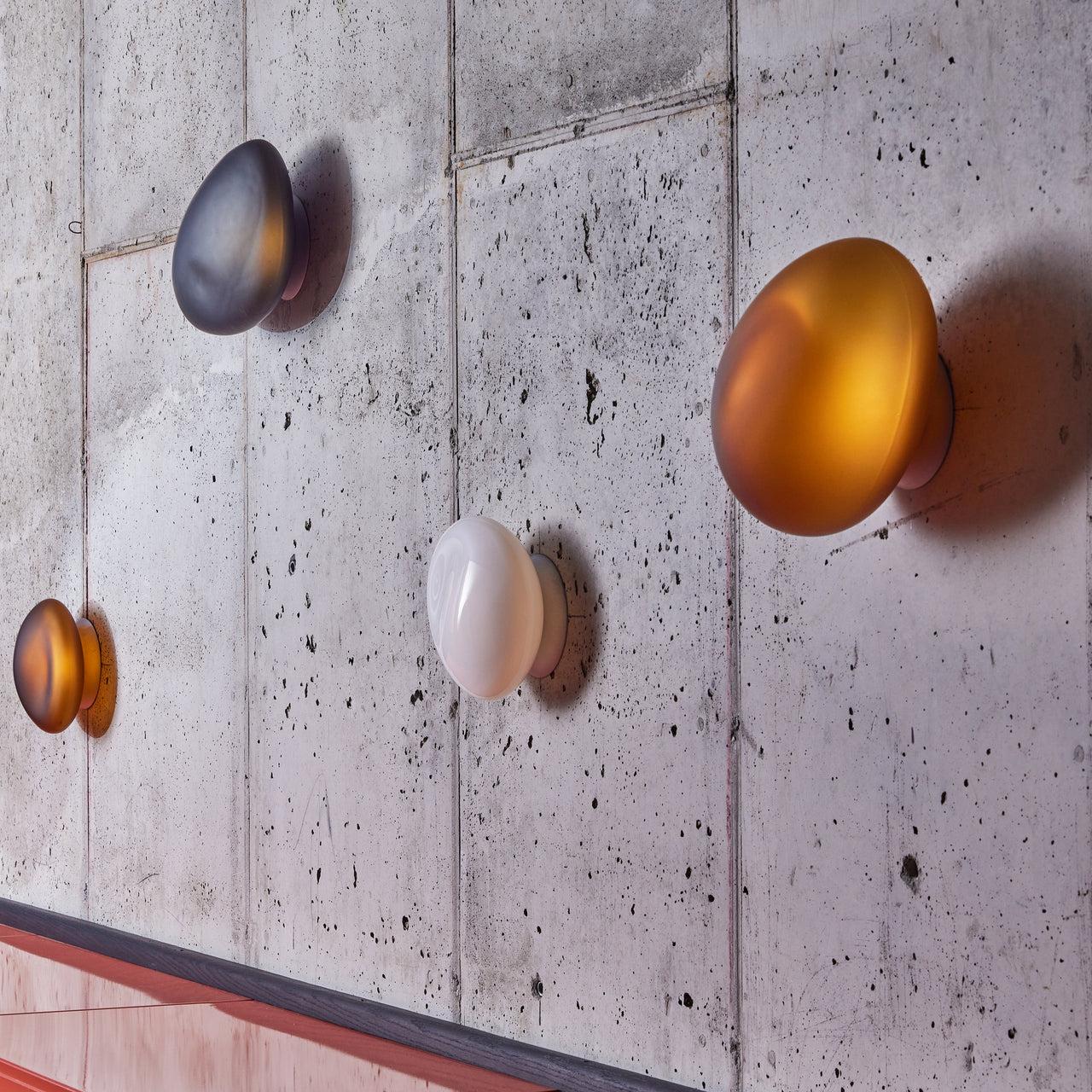 Organic wall lamp family showcasing ceramic, glass and sculptural contemporary designs.