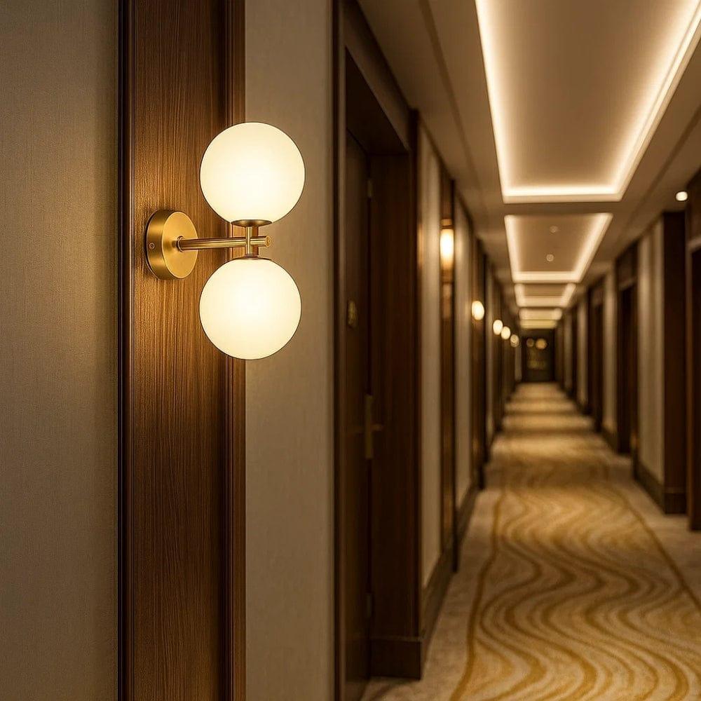 Globe wall lamp installed in a premium hospitality interior with contemporary architectural styling.