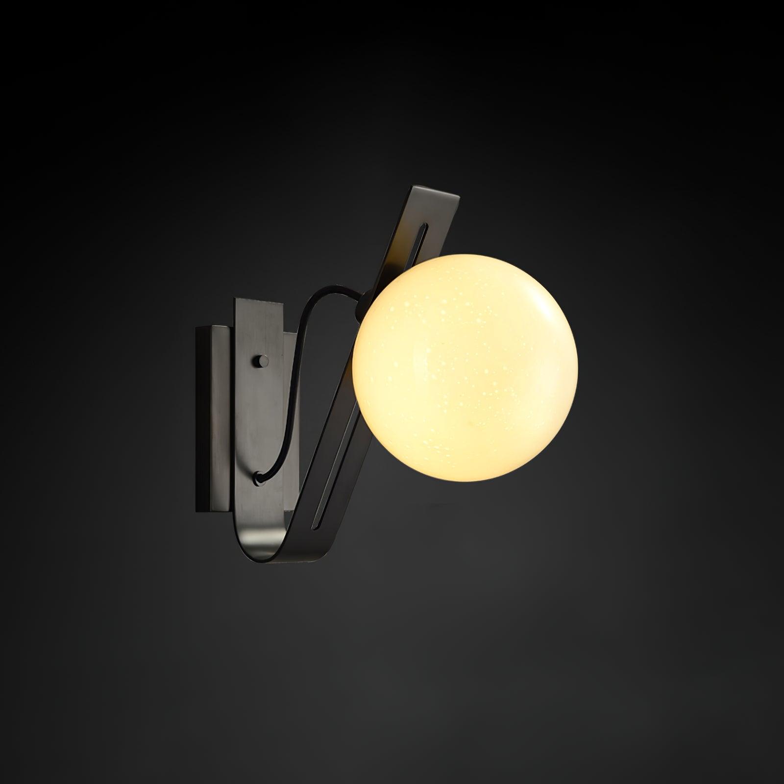 Front view of a contemporary globe wall lamp featuring opal glass and refined metal detailing.
