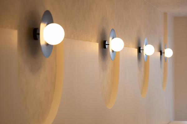 Globe wall lamp installed in a premium hospitality interior with contemporary architectural styling.