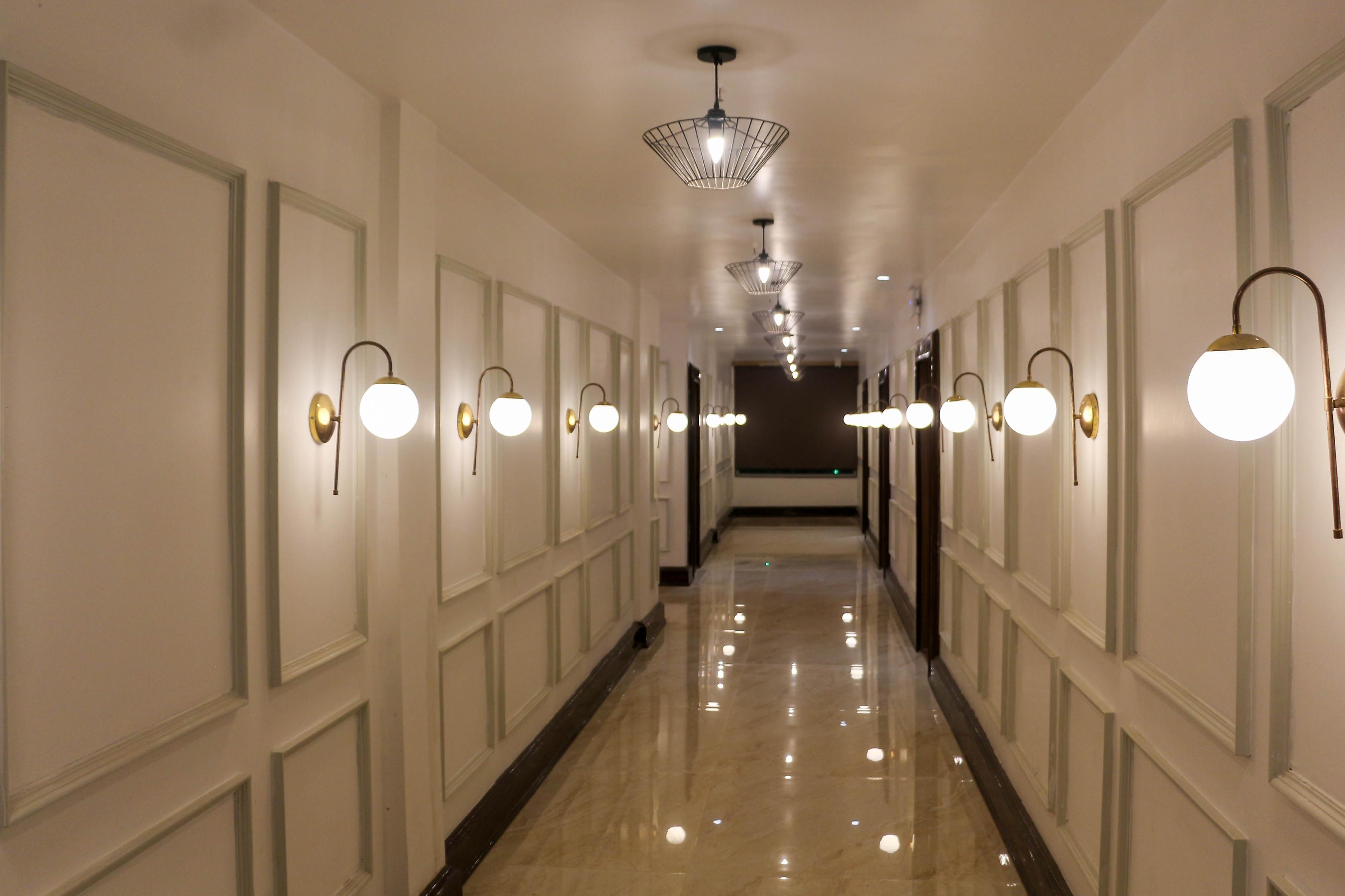 Globe wall lamp installed in a premium hospitality interior with contemporary architectural styling.