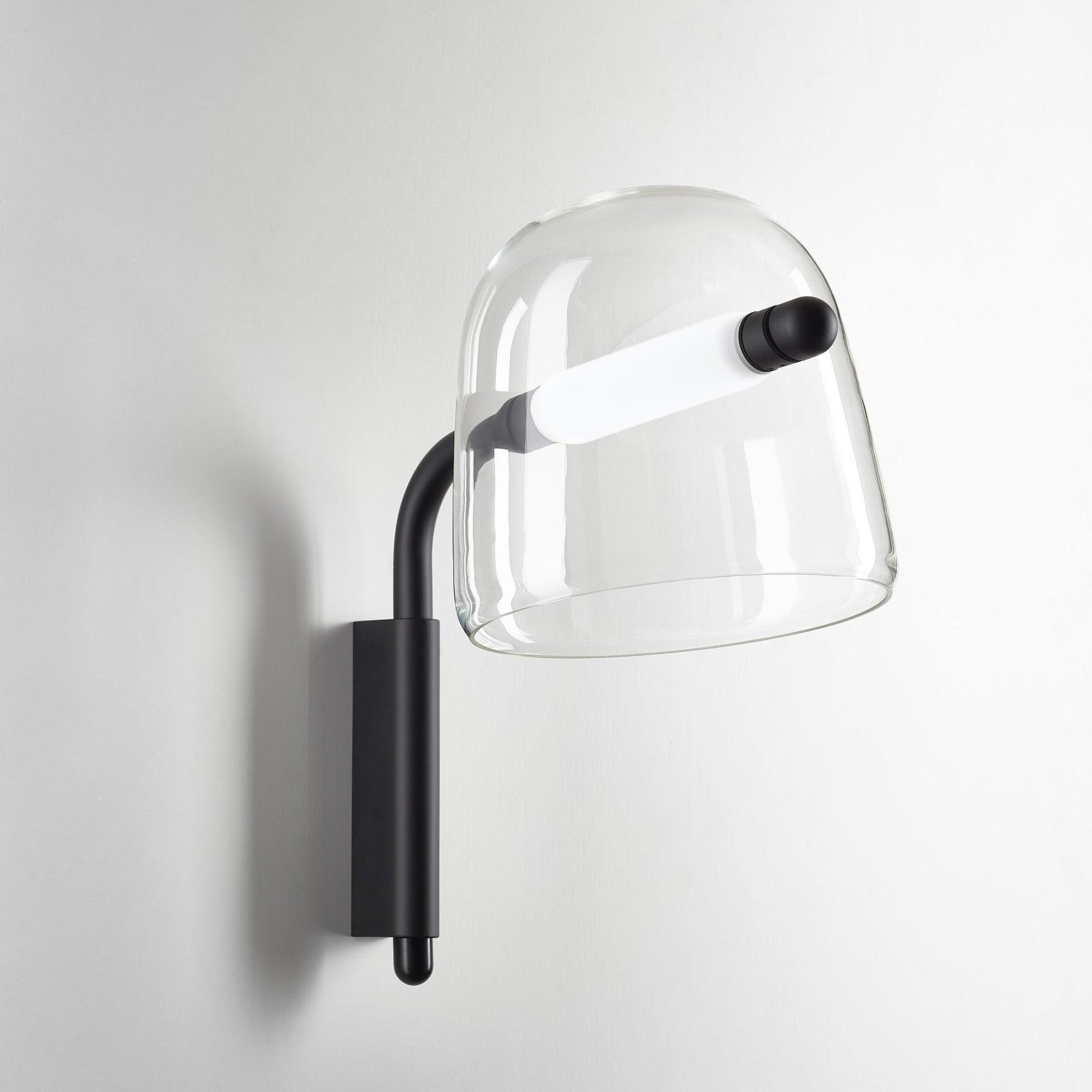 Front view of a contemporary globe wall lamp featuring opal glass and refined metal detailing.