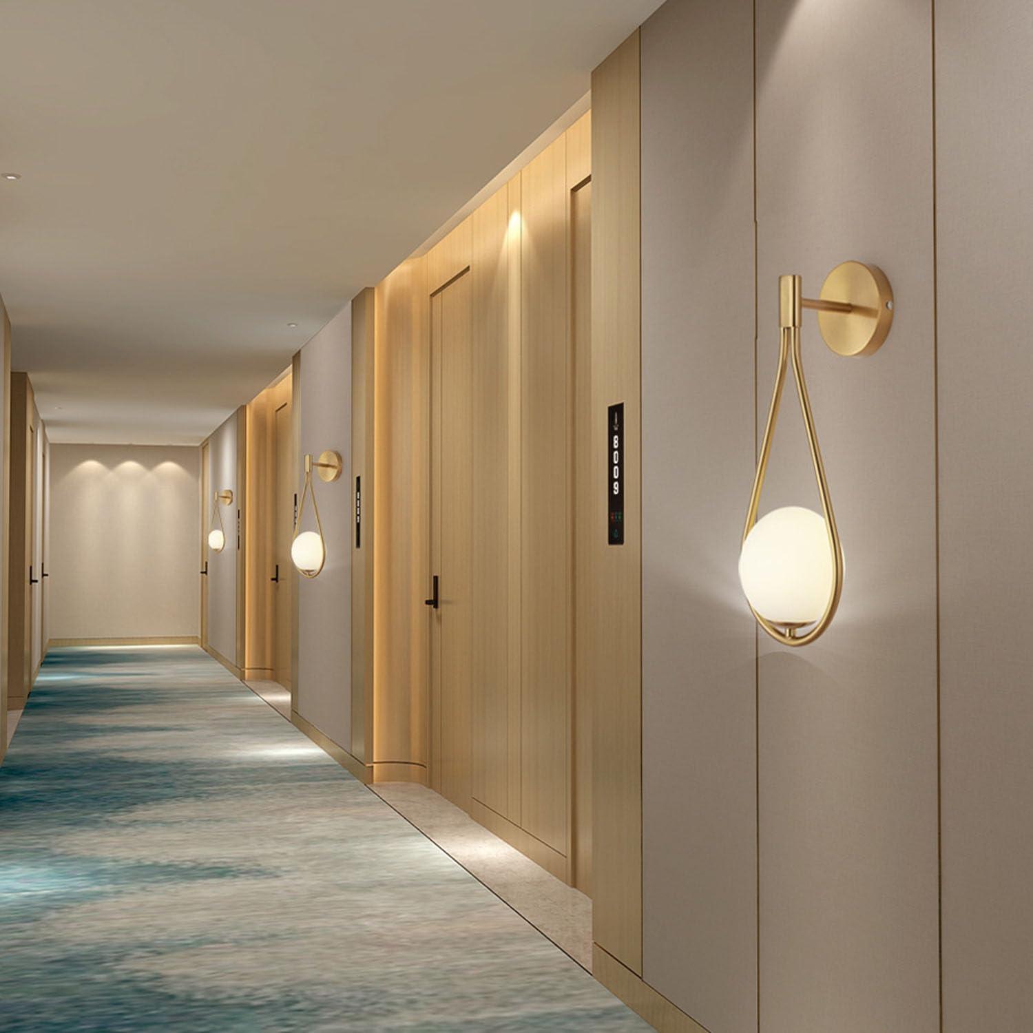 Globe wall lamp installed in a premium hospitality interior with contemporary architectural styling.