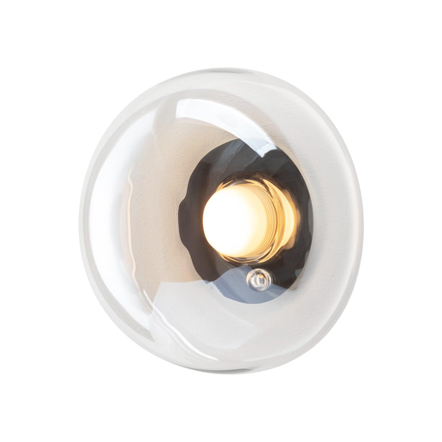 Sculptural wall lamp photographed on a clean white studio background featuring artistic architectural forms.